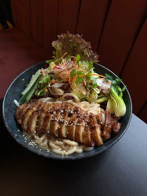 SESAMi - steamed udon noodles in a creamy sesame sauce usually served with crispy tofu, but here served with our unique vegan duck. It is featuring pak choi, cucumber and salad. at IV in Berlin