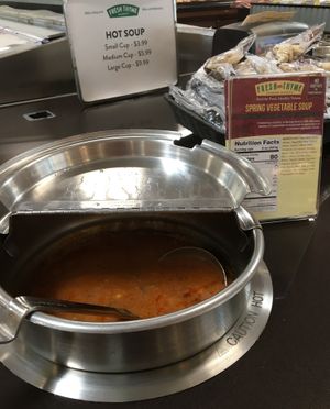 Hot soup bar with clear vegan labeling on the card next to each soup at Fresh Thyme Market in Bloomington