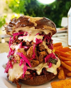 The famous Trio Burger on a pretzel bun 🥨 at Mama Chea Cafe in Davie