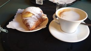 Vegan croissant and cappuccino with soy milk at Sartoria Gastronomica in Bologna