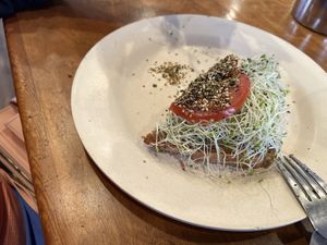 Got half before it was eaten.  My wife had avocado toast with sprouts, tomatoes & firikake on sourdough bread   at Sweet Cane Cafe in Hilo
