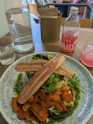 Avocado on sourdough topped with tofu scramble, watercress, tomatoes and bacon. Super filling! at Kollective Kitchen in Sheffield