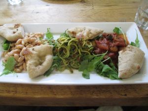 Triple Salad – Warm Caponata, Cannelini bean salad with Walnut sage vinaigrette, romesco courgette ‘Spaghetti’ – served with warm foccacia and rocket leaves at The Green Rocket Cafe in Bath