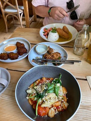 Gnocchi arrabiata (bottom), Katsu curry tofu (top), jalapeño and sweetcorn fritters (left), Tandoori marinated king oysters (middle) at The Green Rocket Cafe in Bath