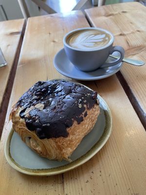 Chocolate and hazelnut croissant with flat oat latte 🌱  at The Green Rocket Cafe in Bath