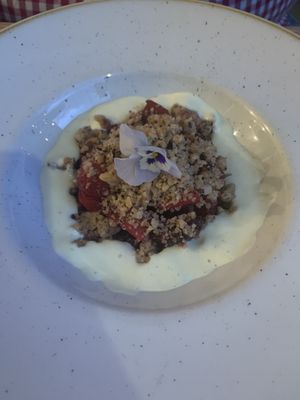 Fruit crumble with a pansy on top! at The Green Rocket Cafe in Bath