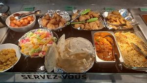 Range of snacks like samosa, aloo tikki, spring roll, papadum, farfar and sweets halva and gulab jamun.  at Pure Veg India in Brussels