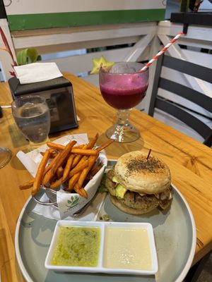 Vegan burger with sweet potato fries and dragon fruit drink   at The Green Spoon in La Fortuna