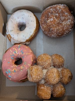 Homer (strawberry with sprinkles), lemon poppyseed, jelly-filled, and donut holes at Doughnut Disturb in Stockholm