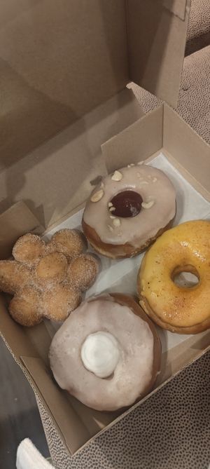 Cinnamon, peanut butter and jelly, mango tahin and pina colada. at Doughnut Disturb in Stockholm