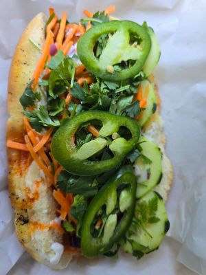 vegan banh mi dog with chili crisp, veganaise, carrots, cilantro & jalapeños at Drop City in Trinidad