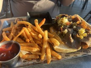 Vegan Italian beef handheld with fries  at Alter Brewing + Kitchen in Oak Brook
