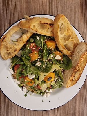 Szabad salad - mixed salad leaves w/ cherry tomatoes, home-made hummus, deep fried "cheese", "feta", "parmesan", seeds, toast at Szabad Bisztró - Új Hely in Budapest