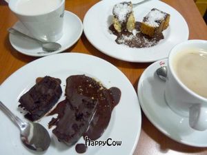 Almond milk coffee, and vegan chocolate and coconut cakes at Mil Tallos in Zaragoza