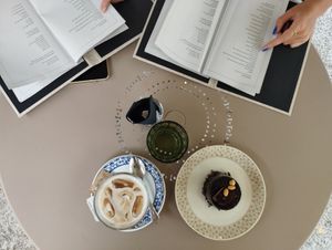 A vegan chocolate cake with peanut and caramel pairs great with an iced oat latte! at Makramè in Ljubljana
