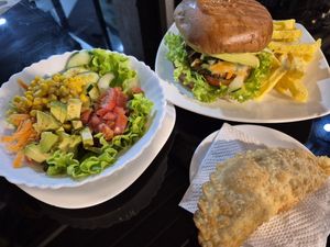 Mixed salad, vegan Burger and vegetable Empanada at Restaurante Lucky in San Cristobal