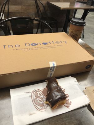 Chocolate glazed vegan donut with almond milk latte! at The Donuttery in Huntington Beach