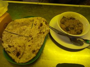 Garlic naan not really good 10k kips. Egg plant curry 22k kips was so good!! at Nisha Restaurant in Luang Prabang
