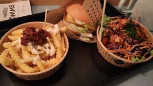 Garlic fries, pink burger and garden salad at Swing Kitchen - Invalidenstraße  in Vienna