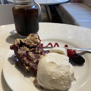 Marionberry pie with hazelnut and a scoop of vanilla ice cream. Amazing ice cream! at Petunia's Pies and Pastries in Portland
