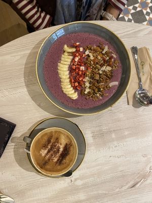 Red smoothie bowl and capuccino  at The Veg Box Cafe - London in North West London
