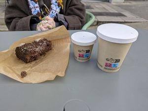 Brownie de coco vegano, café macchiato con leche de avena, y café negro doble. at Coffee Muxu in Bayonne