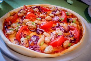 pizza vegana uno - white beans, tomatoes and red onions at Pizzeria Macondo in Trebon