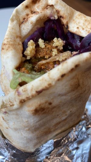 Recent falafel in wrap with as much cous cous and cabbage as he could fit in for me   at Lazeez Falafel Salad Bar in Durham