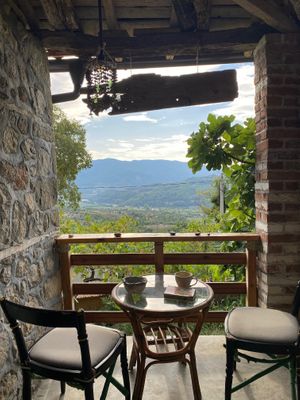 Terrace seating  at The House in the Village in Pellumbas