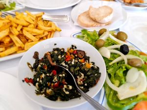 The vegan dish: homemade chips with skin, sautéed veggies and salad. at O Pelourinho in Alijo