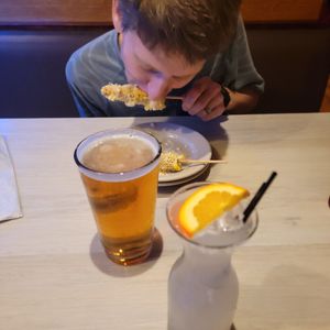 Husband trying Elote Corn at La Rumba Restaurant Latino in Asheville