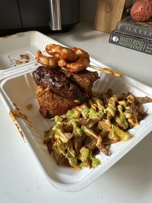 Vegan shrimp, steak, mofongo under with yellow rice w/green olives. Fries on the side!  at House of Mofos in Orlando
