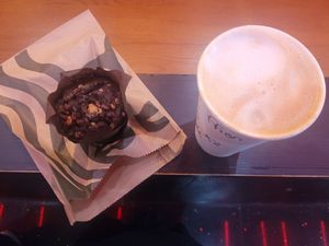 Chocolate and Caramel Muffin and Almond Biscotti Oat Latte at Starbucks Coffee in Broughton