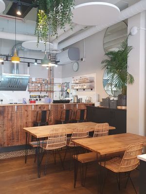 Seating and kitchen at Mood Cafe in London