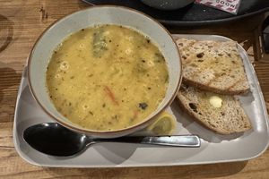 Hearty lentil soup with sourdough bread .  at Mood Cafe in London