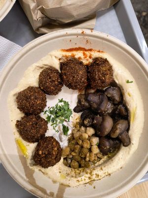 Complete hummus bowl with mushroom, falafel and chickpeas at Hummusbar in Budapest