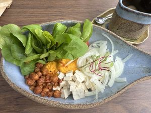 Tofu bowl with carrot hummus, crunchy chickpea, and salad 🥗   at YUCAFÉ in Sao Paulo
