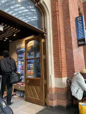Upstairs in St. Pancreas Station, two tables by entrance to shop  at Greggs - St Pancras Station in North West London