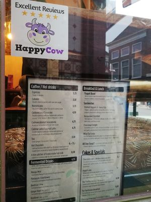 HAPPY COW approved window sticker above the current menu! at Parrhesia Cafe in Groningen