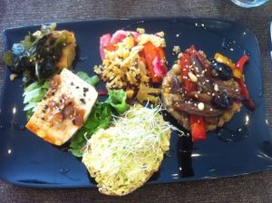Seaweed/tomato cake, quinoa risotto with roasted veg, homemade turmeric "cheese" on delicious fresh bread, marinated tofu at Carmen Ragosta in Paris