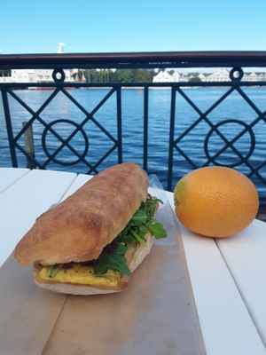 Ciabatta Breakfast Sandwich - plant-based eggs florentine, "cheese", tomato jam, & arugula at BoardWalk Bakery in Orlando