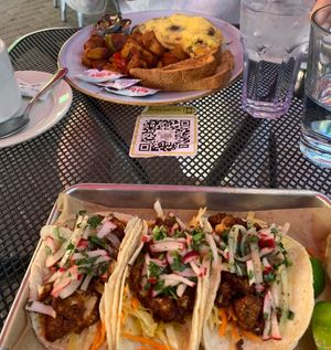 Lower plate is vegan cauliflower tacos. Upper is non vegan breakfast.  at Busboys and Poets - Shirlington in Arlington