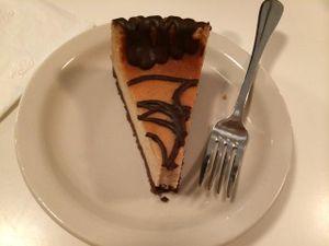 peanutbutter cheesecake with one delicious bite missing  at Peacefood Cafe - Downtown in New York City