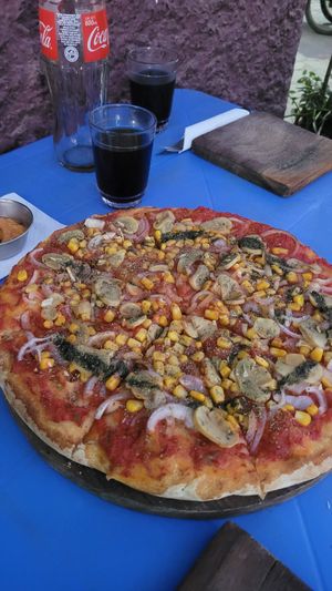 Vegan Pizza with Onion, Mais, Tomatos, Mushrooms at La Pizzeria Samaipata in Samaipata