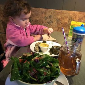 Della taking apart some yummy grape leaves  at iCreate Cafe in Pottstown