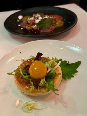 Caramelized Onion Tart with yellow tomato egg yolk, frisée and mushroom pancetta. at Crossroads Kitchen in Los Angeles