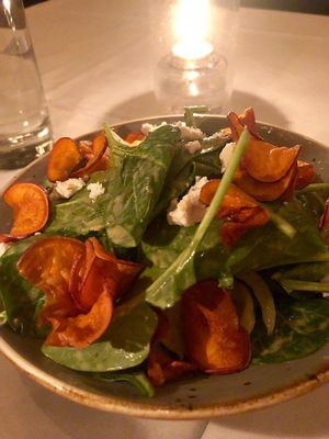 Delicious spinach salad with "cheese" and sweet potatoe chips at Crossroads Kitchen in Los Angeles