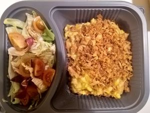 Vegan "Kasnockerl" with roasted onions and salad at Cafe Harvest in Vienna