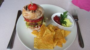 Vegan burger with tortilla chips and guacamol/ ketchup with persley :) at Cafe Harvest in Vienna