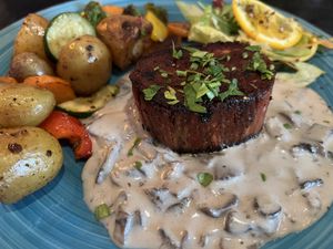 VILET MIGNON, With mushroom cream sauce,
oven vegetables and in baby potatoes fried in their skins, salad bouquet
  at Cafe Harvest in Vienna